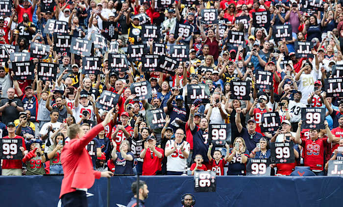 Texans player J.J. Watt waves while fans cheer after Watt is inducted into the Texans Ring of Honor during the game against the Pittsburgh Steelers at NRG Stadium.